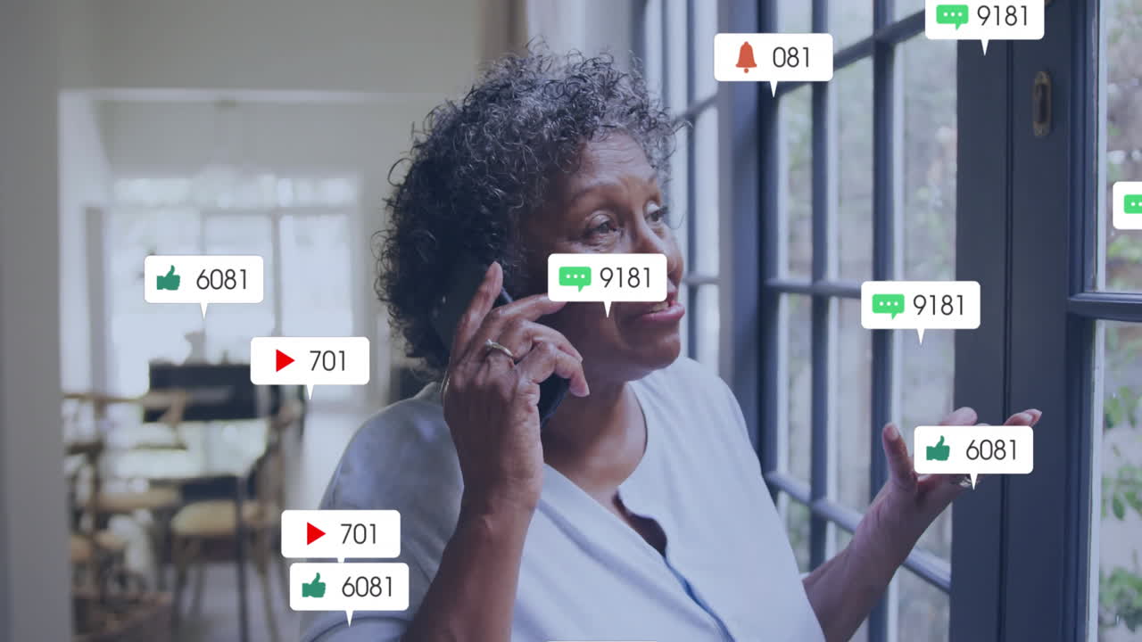 Social media notifications animation over woman talking on phone near window