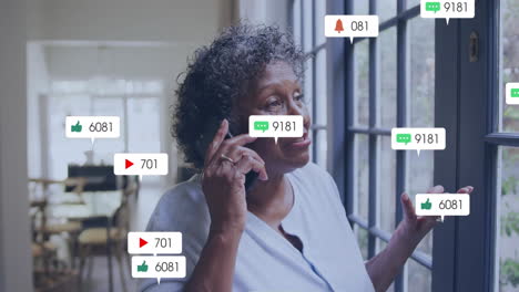 social media notifications animation over woman talking on phone near window