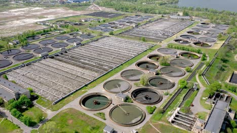 aerial shot of a wastewater treatment plant and distant skyline. big city waste processing concept