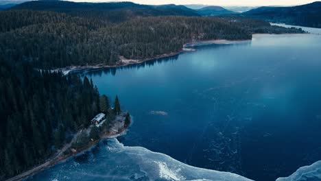 aerial view of omundvatnet lake surrounded by the mountains in winter in indre fosen, trondelag, norway