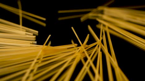 spaghetti falling very beautiful in a circle on a mirror surface in slow motion