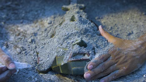 Maya-jade-mask-being-discovered-by-an-archaeologyst