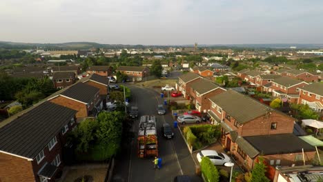 Aerial-View,-footage-of-Dustmen-putting-recycling-waste-into-a-garbage-truck,-Bin-men,-refuse-collectors