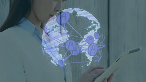 using tablet, businesswoman viewing global network connections animation in office