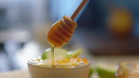 honey is being poured into a mug in slowmotion