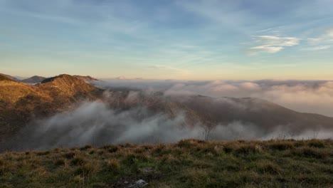 Misty-sunrise-over-the-hills-of-Genoa,-Liguria,-Italy,-with-rolling-clouds-and-tranquil-morning-light,-timelapse