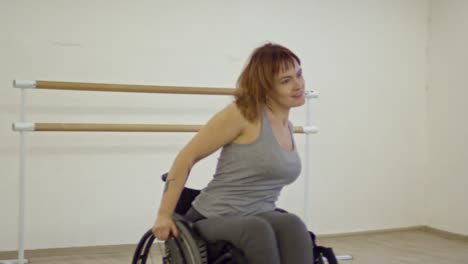 woman in wheelchair dancing energetic dance with male partner