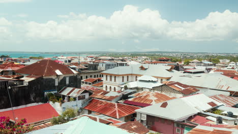 rustic rooftops of stone town, zanzibar, with ocean backdrop