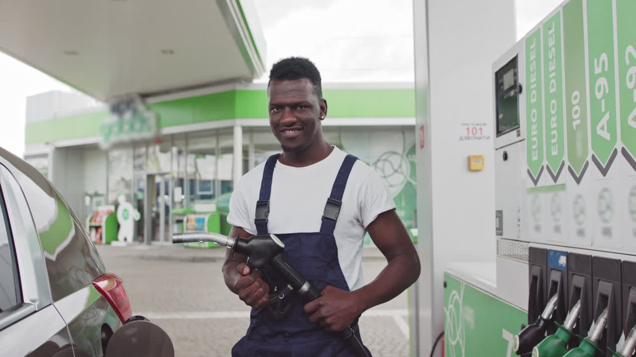 Man refueling a car at a gas station