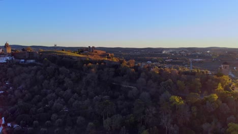 drone shot backing drone shot backing out and turning, filming a hill with some medievalbuildins on in alentejo, portugal