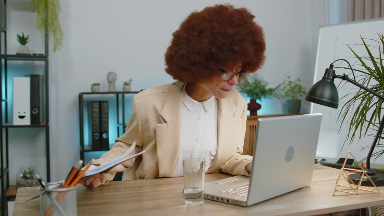 Focused business woman girl at office reads social media news accidentally spilled water on laptop