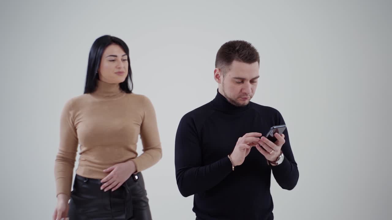 Business people isolated on grey. Successful business couple standing in studio