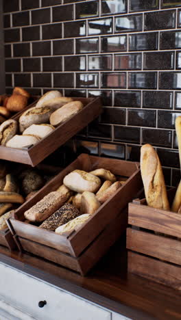 assortment of freshly baked bread in wooden crates at a bakery