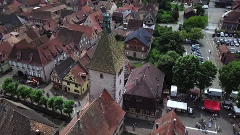 a rearward footage moving around the clock tower while revealing the rest of the village