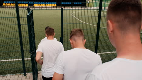 Male-Street-Football-Team-Entering-The-Pitch-And-Training