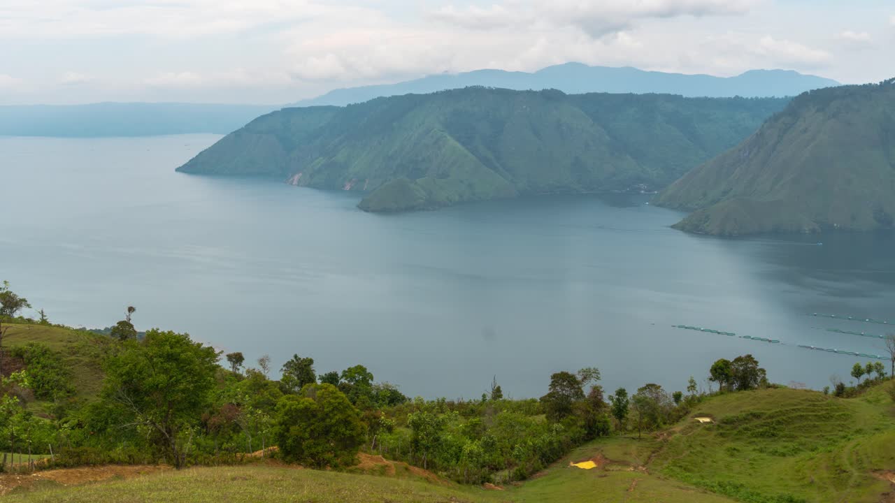 Panoramic View of Lake Toba Surrounded by Lush Green Mountains