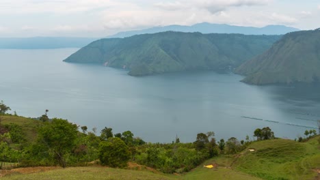 panoramic view of lake toba surrounded by lush green mountains