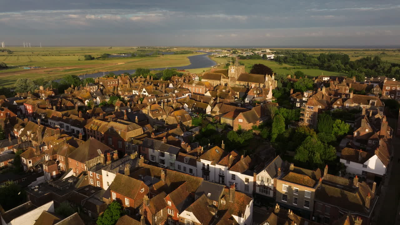 English Village In Rye, East Sussex With View of St Mary's Church And River Rother At Dusk. aerial pullback shot