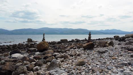 balanced spirituality meditation pebbles piled on alien rocky mountain range beach coastline push in between towers