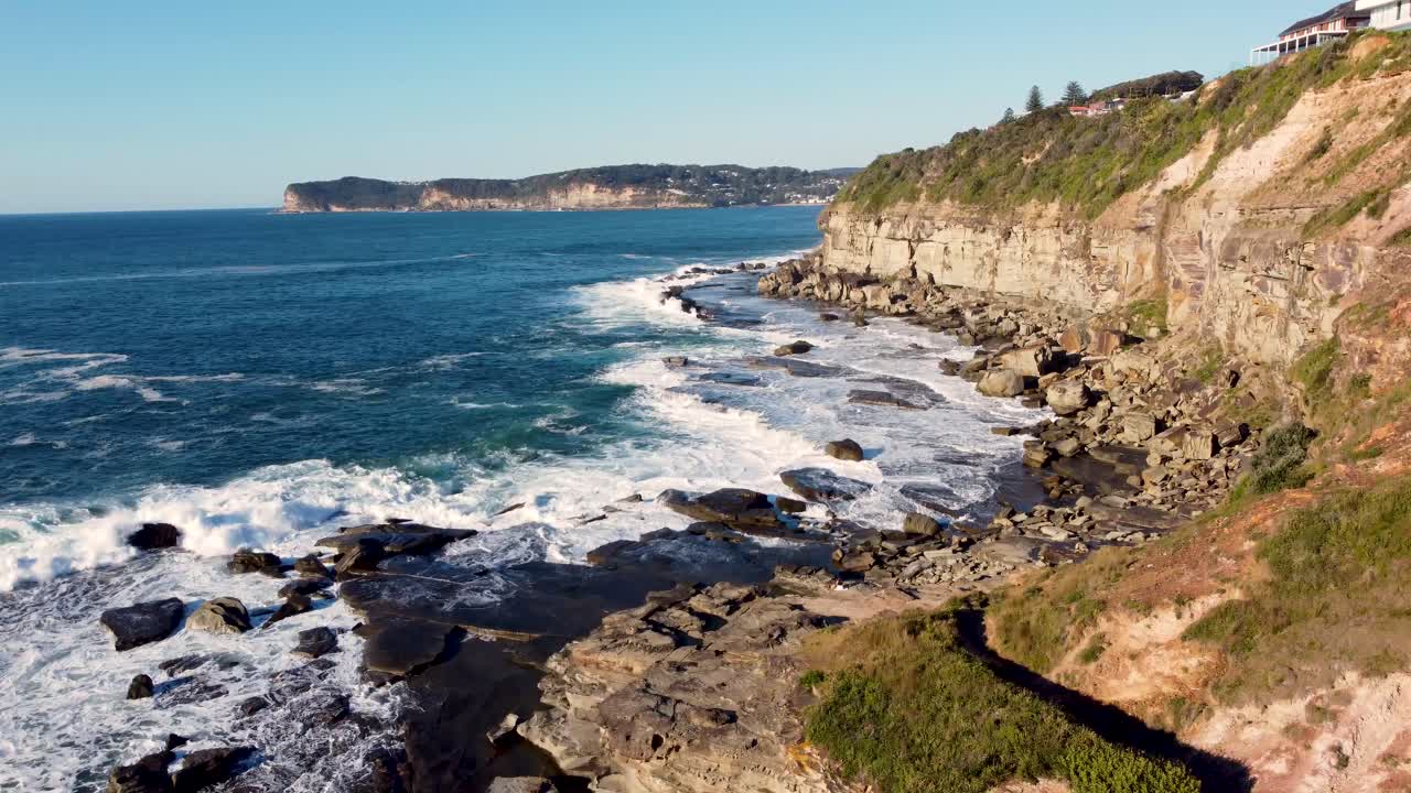 Drone aerial pan shot of North Avoca and Terrigal Headland on the Central Coast Pacific Ocean Waves Tourism NSW Australia 4K