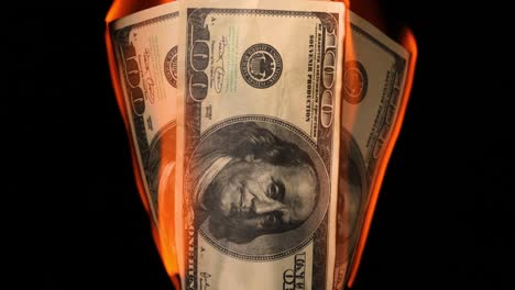 USA-dollar-bill-money-is-burning-in-the-fire,-the-concept-of-the-economic-crisis-of-inflation-and-currency-devaluation.