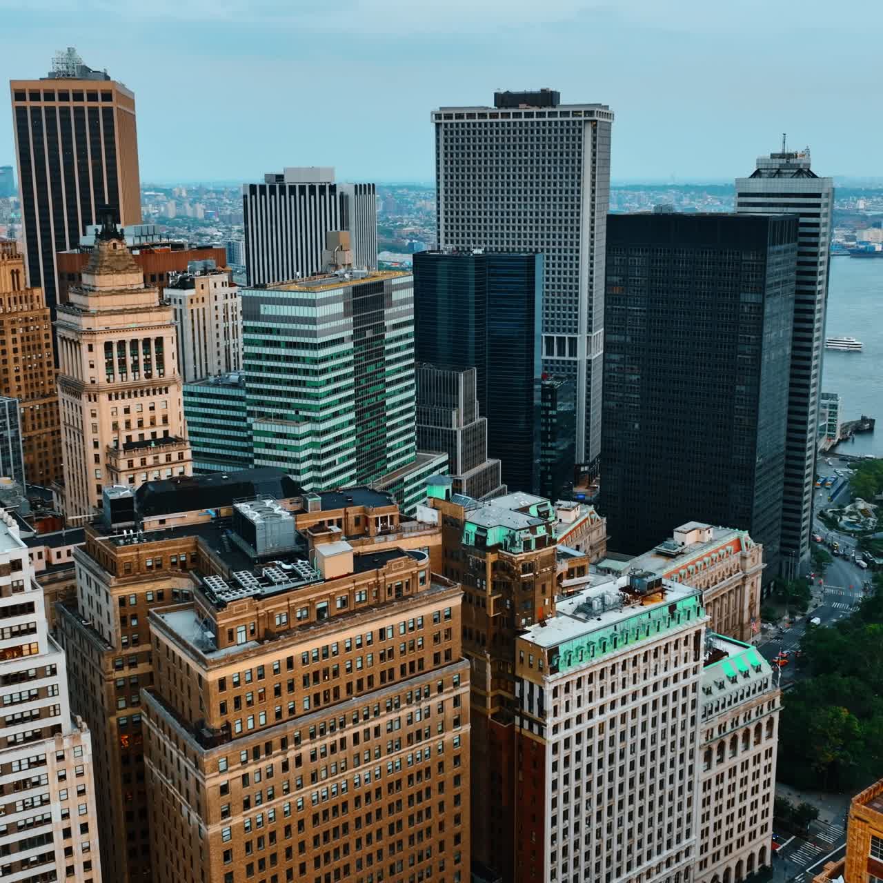 Approaching the tops of various skyscrapers in the New York Midtown. Gorgeous buildings at sundown from top view