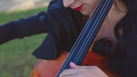 woman playing cello outdoors
