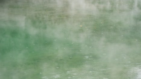 thermal valley hot spring lake smoky surface rain water ripple in beitou, taiwan taipei