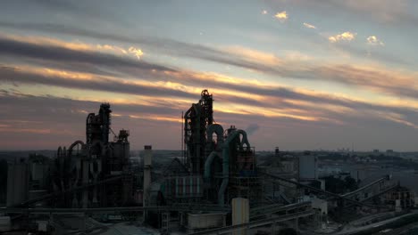 sunset over a cement factory