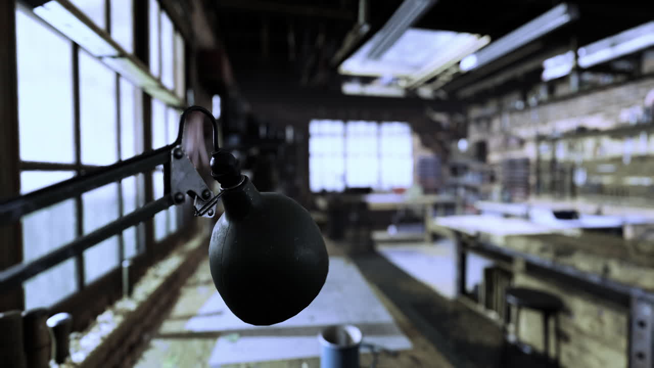 Workshop interior with vintage lamp illuminating workspace during daylight