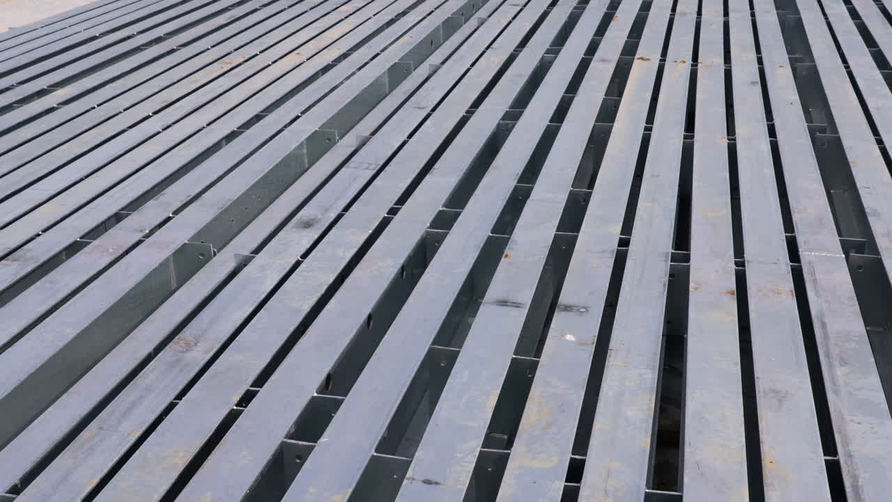 An abstract move and tilt over steel awaiting construction