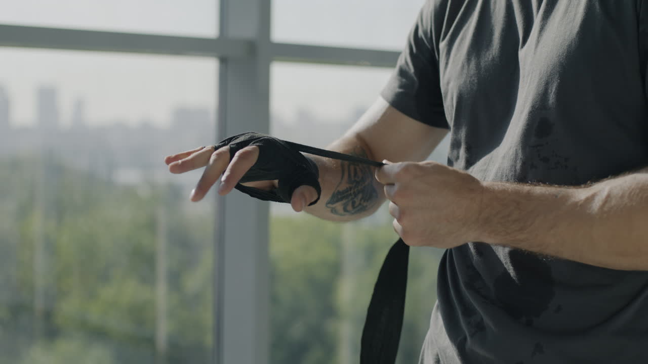 Man wrapping boxing hand wraps
