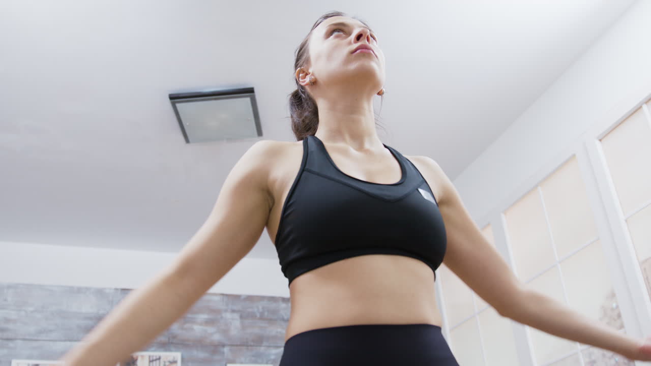 Woman exercising indoors wearing a sports bra