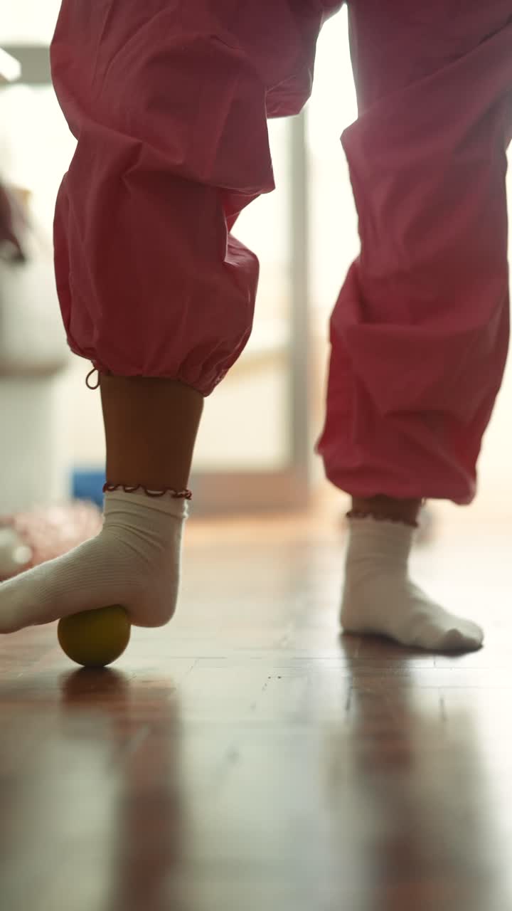 Child playing with a ball on the floor