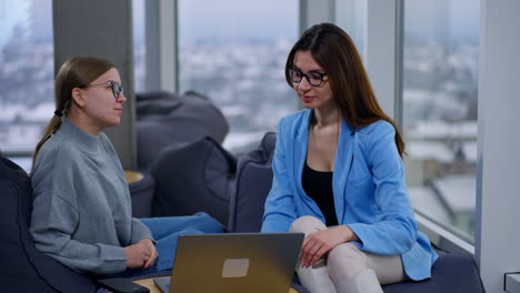 businesswomen in conversation at a modern office