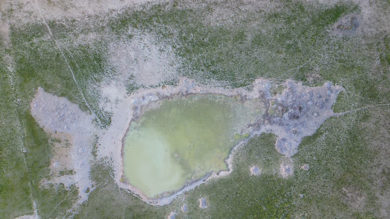 Aerial view of a seasonal depressional wetland or pan with game trails in the arid kalahari region of southern Africa