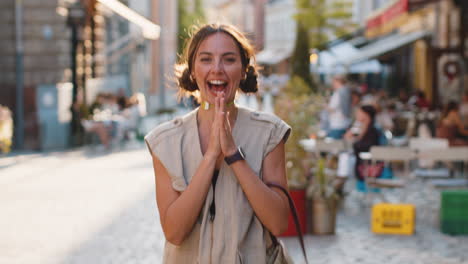 young woman shouting celebrating success winning goal achievement good victory news in city street