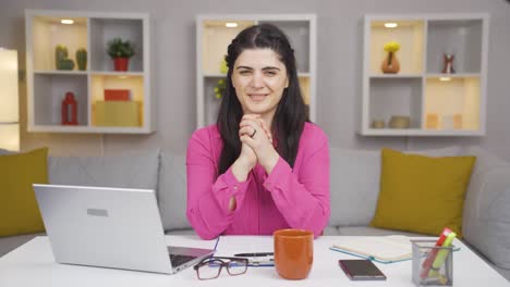 Home-office-worker-woman-makes-a-trust-sign-to-the-camera.