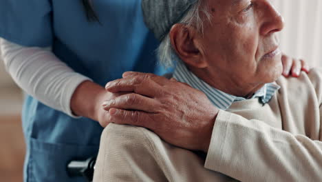 a nurse comforts an elderly man in a wheelchair