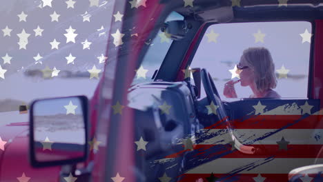 Animation-of-flag-of-usa-over-caucasian-woman-by-car-on-beach