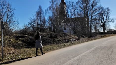 Brunette-Woman-Is-Walking-On-The-Road-In-Rural-Town