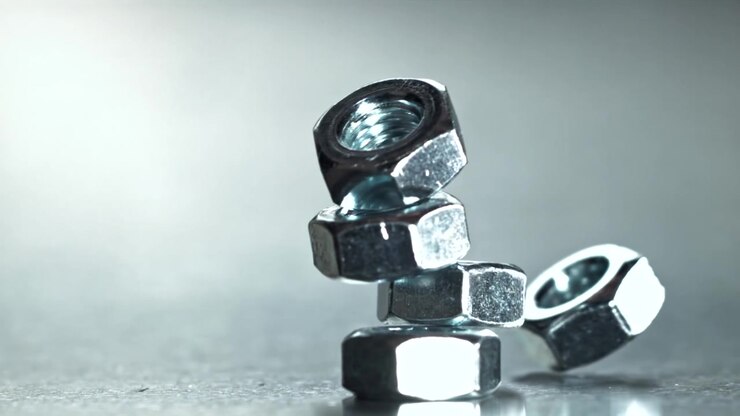 Close-up of Metal Nuts Falling and Collapsing in Slow Motion
