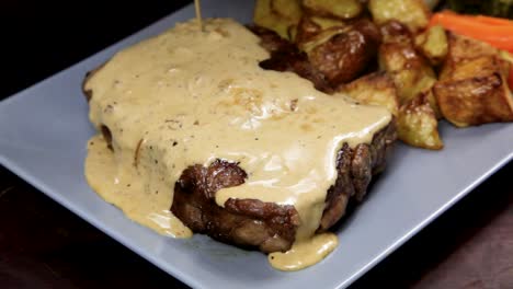 Sauce-being-poured-over-a-steak.