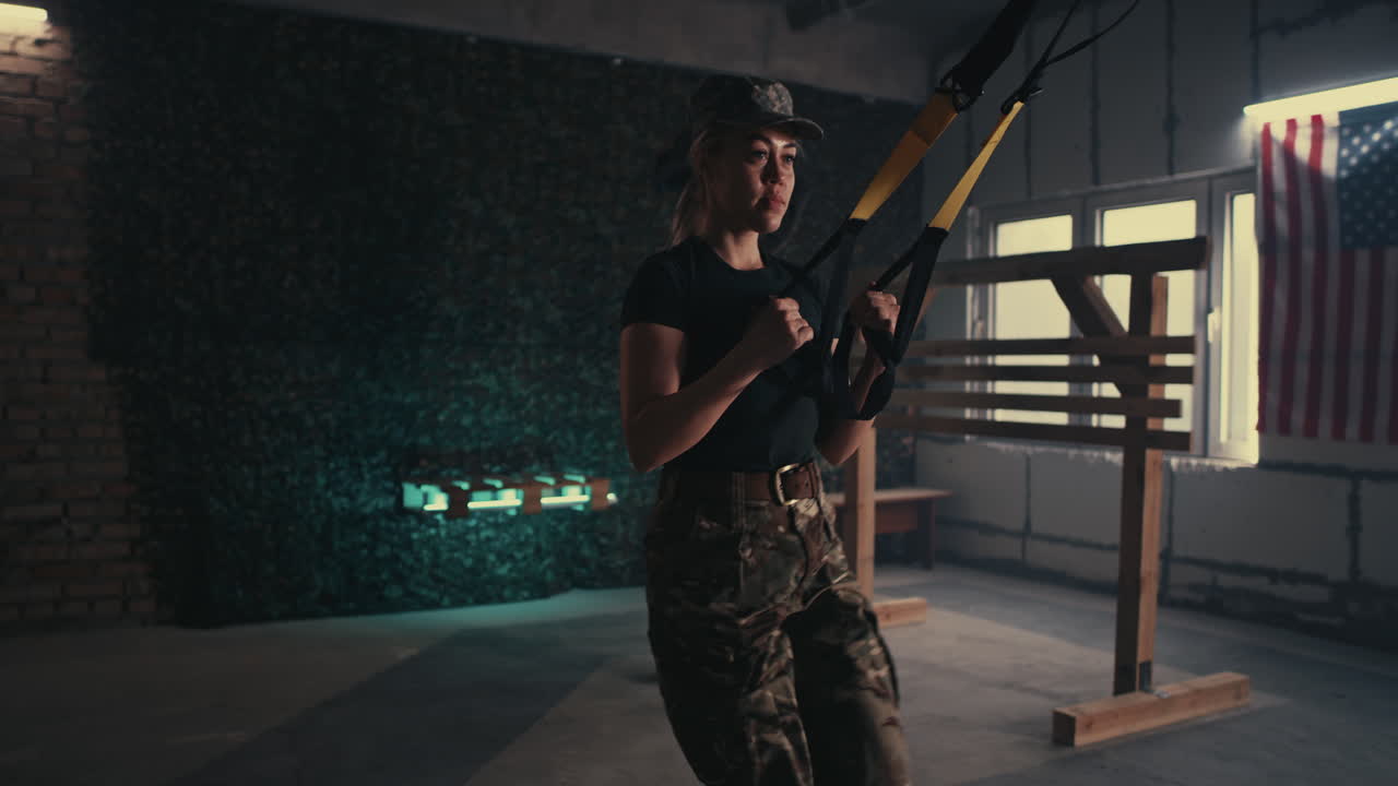 Woman in Military Uniform Doing Suspension Training