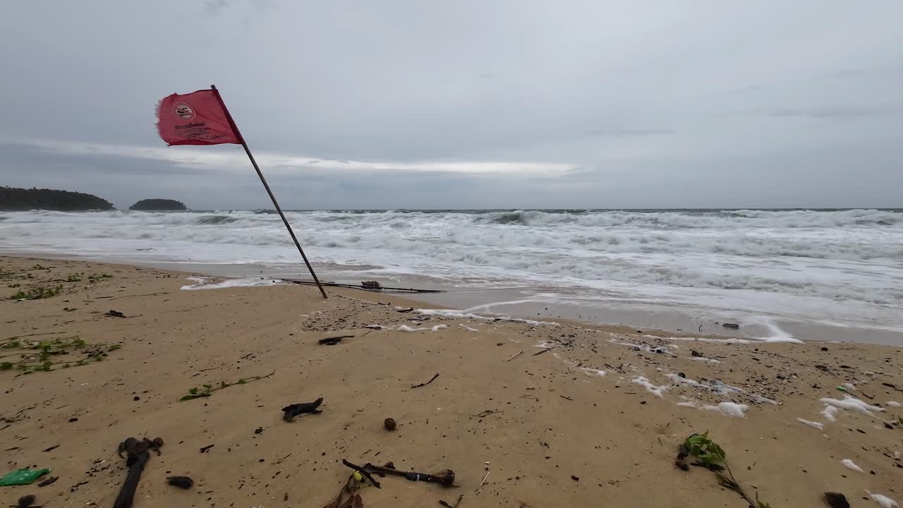 Red Warning Sign No Swimming at Karon Beach Phuket Thailand.Monsoon Season with heavy waves and Strong current.
