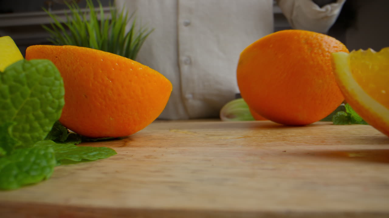 Cutting Oranges on Wooden Board