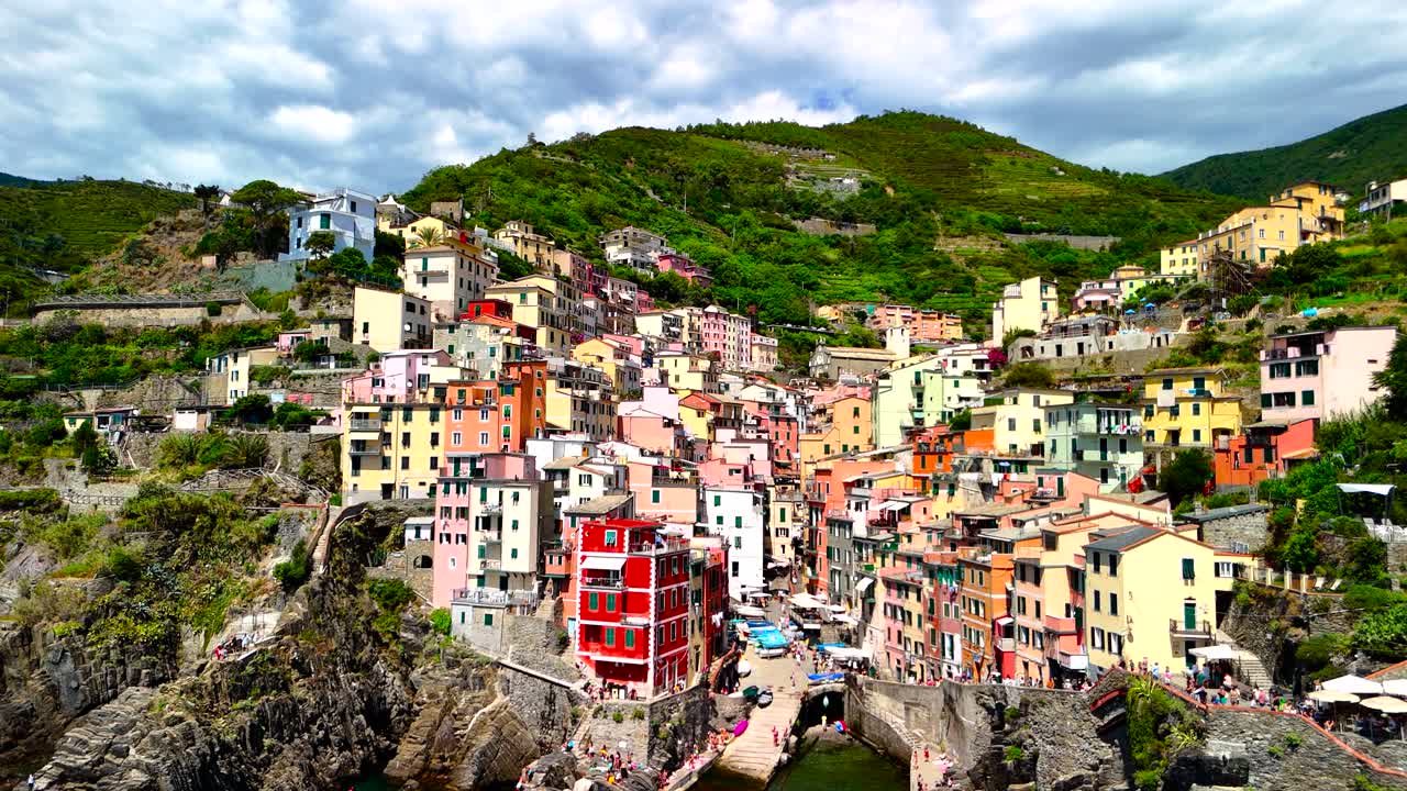 Explore the vibrant buildings of Cinque Terre, Italy, perched on cliffs by the sea. Enjoy scenic views of the coastline and charming architecture in this picturesque location