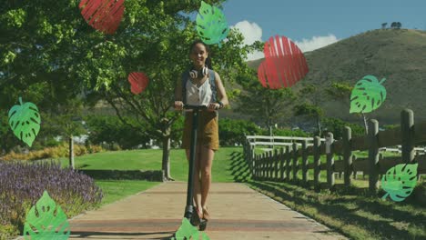 hojas verdes e iconos de corazón rojo contra mujer afroamericana montando scooter eléctrico en el parque