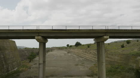 bridge over dried up concrete sluice riverbed of dali mta reservoir