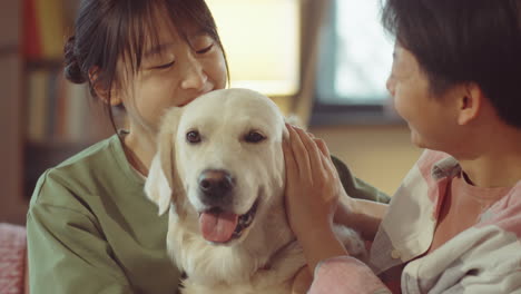 young asian women petting lovely dog at home